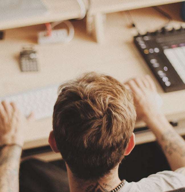 man producing music at desk