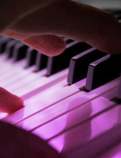 close up of hand playing piano