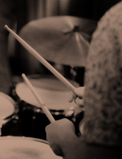 close up of someone sitting at drum kit