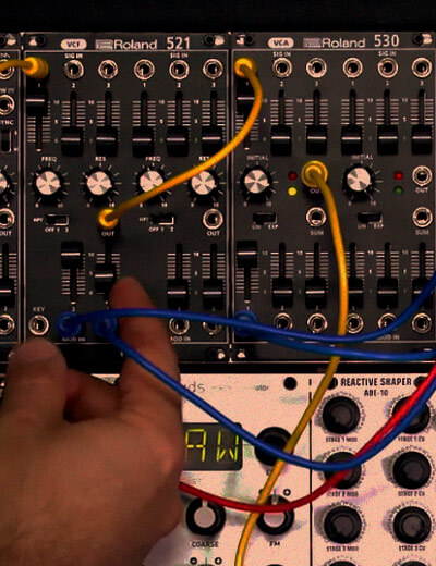 hands over modular synthesizer